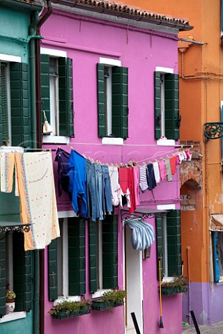 Washing hung out to dry on houses on the island of Burano in the Venice Lagoon Veneto Italy