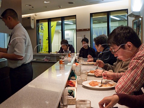 People eating in a curry restaurant in Tokyo station  Japan