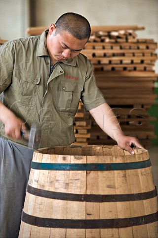 Worker making a barrel at Bodega Langes winery near Chang li Chang Li Hebei Province China