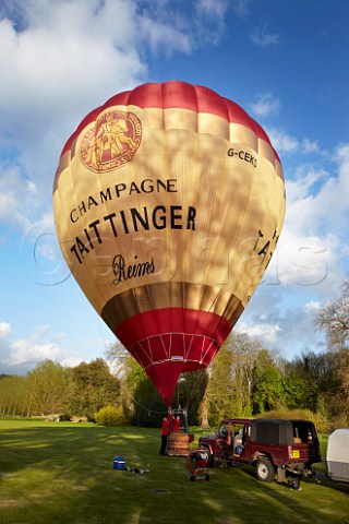Inflating the Taittinger hotair balloon in the grounds of Bibury Court Hotel Gloucestershire England