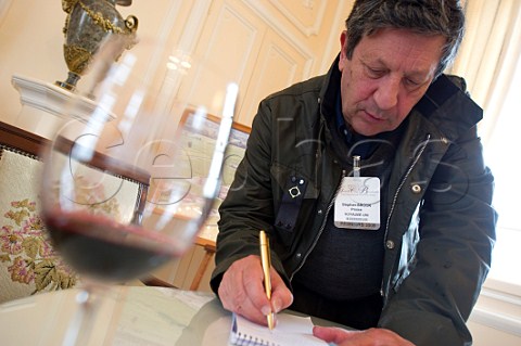 Stephen Brook making notes at En Primeur tasting of the 2009 vintage    Bordeaux France