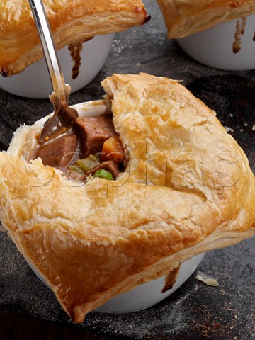 Beef and Guiness pies on a baking sheet