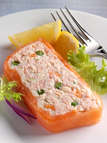A whole salmon terrine with a slice taken off