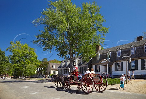 Horsedrawn carriage passing the Kings Arms Tavern on Duke of Gloucester Street Colonial Williamsburg Virginia USA