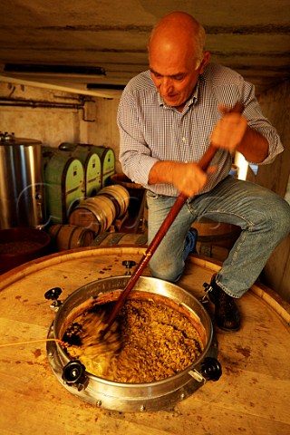 Niccol Bensa hand plunging the grapeskin cap on a vat of fermenting Ribolla Gialla  La Castellada Oslavia Friuli Italy    Collio