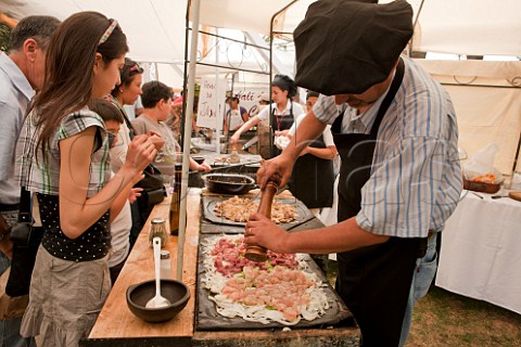 Preparing chicken beef and pork with onions to barbecue during La Fiesta de la Vendimia in Santa Cruz Colchagua Valley Chile