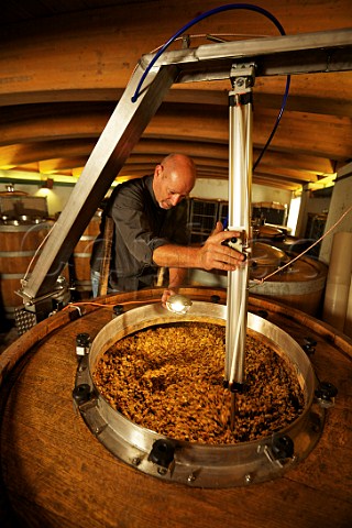 Stanko Radikon punching down the grapeskin cap with a pneumatic plunger in a tank of fermenting Ribolla Gialla Radikon Oslavia Friuli Italy  Collio