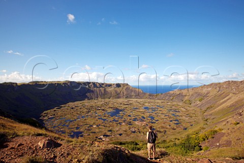 Tourist viewing Rano Kau an extinct volcano crater near Orongo village Easter Island