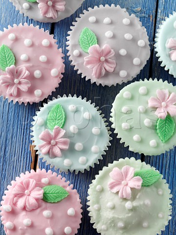 Flower iced cupcakes on a blue background