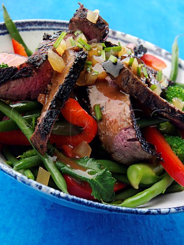 Chargrilled fillet steak strips with vegetable salad honey ginger dressing