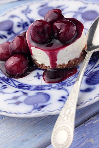 Individual cherry cheesecake on an antique plate