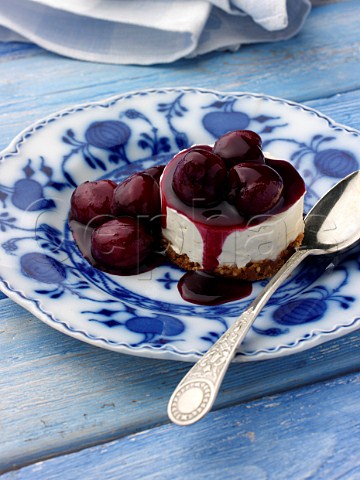 Individual cherry cheesecake on an antique plate