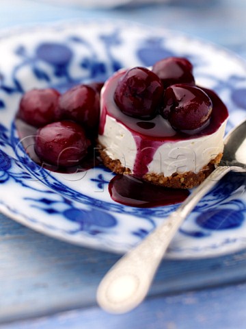 Individual gluten free cherry cheesecake on an antique plate