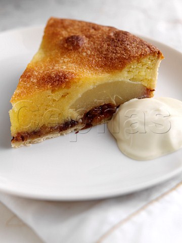 Individual slice of frangipane fruit cake and cream