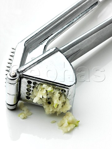 Garlic press with garlic squeezing out