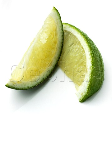 Two lime slices on a white background