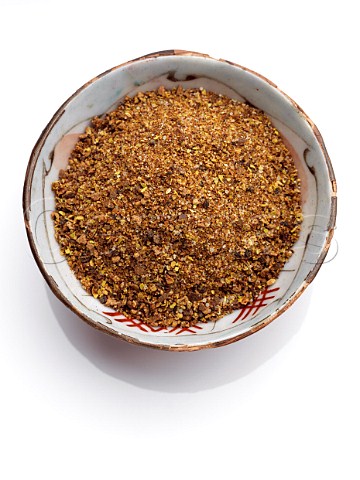 A bowl of Jamaican Jerk spice on a white background