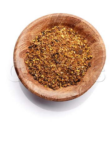 A bowl of Jamaican Jerk spice on a white background