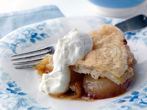 Individual portion of caramelized apple pie on an antique plate