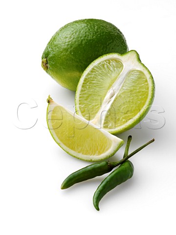 Limes and chillies on a white background
