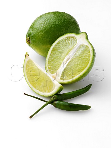Limes and chillies on a white background