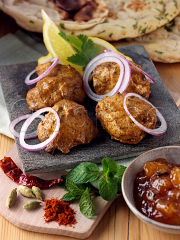 Chicken tikka with red onion slices and spices