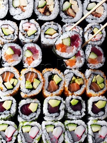 Entire frame sushi overhead withchopsticks lifting a sushi