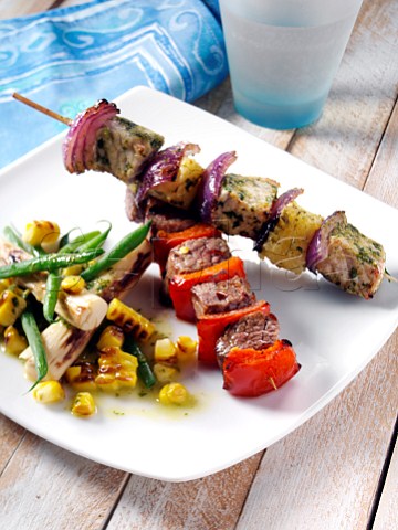 Pork and pineapple and chilli beek kebabs with corn and palm heart salad