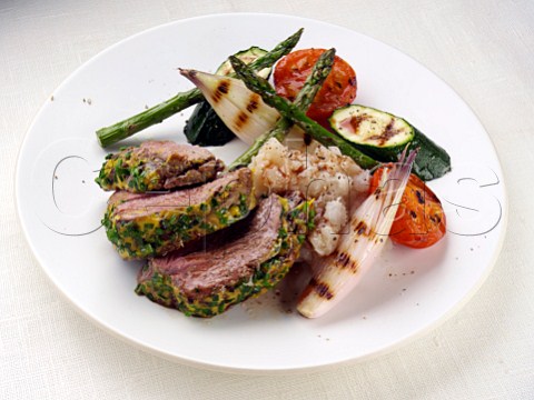 Lamb rump with a herb and mustard crust asparagus shallaots courgettes and tomatoes