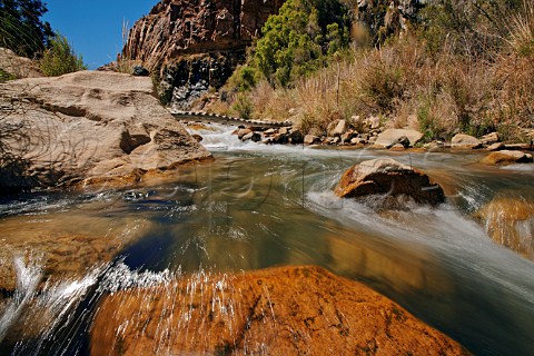 Small wooden bridge over the fastflowing Elqui River formed by meltwater from the Andes Elqui Valley Chile     