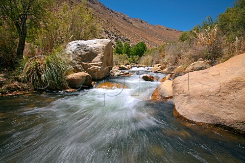 The fastflowing Elqui River formed by meltwater from the Andes Elqui Valley Chile