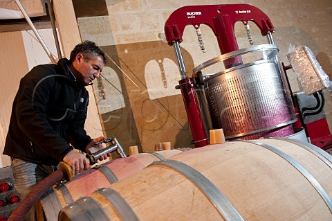 Filling barriques with new wine Bucher basketpress behind Chteau de Rocheyron StChristophedesBardes Gironde France  Stmilion  Bordeaux