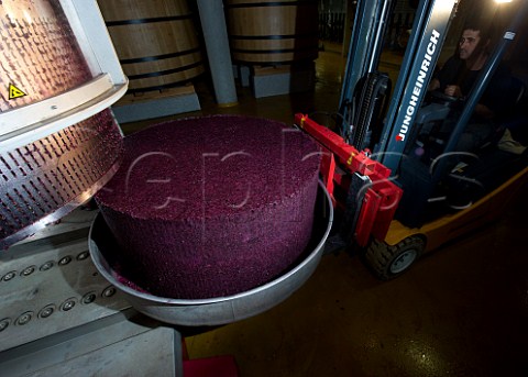 Removing the compressed grape skins from the press after the press wine has been extracted  Chteau Faugres StEtiennedeLisse near Saintmilion Gironde France Stmilion  Bordeaux