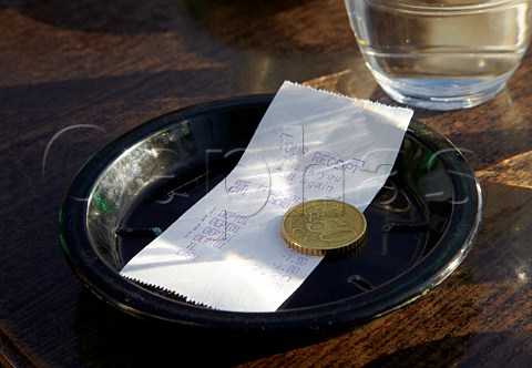 Receipt in English and 50 cent coin on table of a Paris caf Paris France
