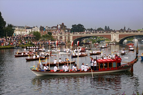 Friday 27 July 2012 Flotilla of boats on River Thames at Hampton Court Bridge waiting to follow the Olympic flame downstream to London England