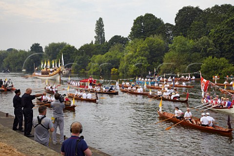 Friday 27 July 2012 Flotilla of boats following the Gloriana rowbarge carrying the Olympic Flame on River Thames at Hampton Court on its way to London  England
