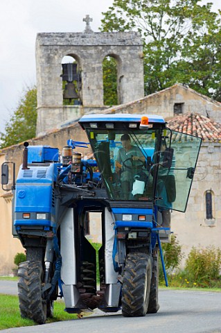 Harvesting machine on road in village of Cardan Gironde France  Premires Ctes de Bordeaux  Bordeaux