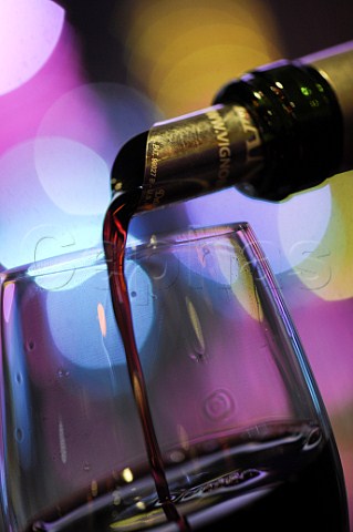 Pouring glass of red wine at a party