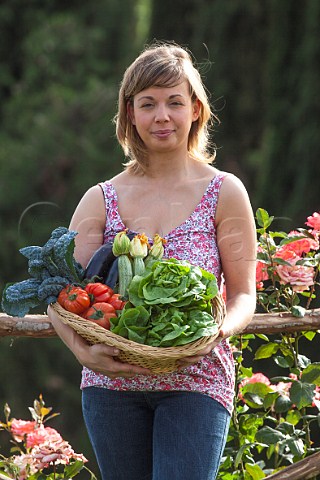 Sarah Fioroni cookery writer with a basket of organic vegetables grown at Fattoria Poggio Alloro San Gimignano Tuscany Italy