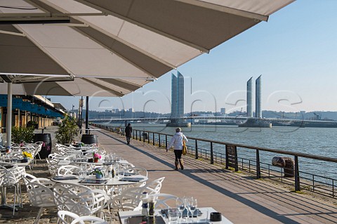 Caf tables on the Quai de Bacalan with the ChabanDelmas Lift Bridge over the Garonne River Bordeaux Gironde France