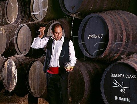 Venenciador filling glasses with Manzanilla from barrel in the Cathedral bodega of Antonio Barbadillo Sanlcar de Barrameda Andaluca Spain   Manzanilla  Sherry