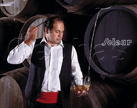 Venenciador filling a glass with Manzanilla in the Cathedral bodega of Antonio Barbadillo Sanlcar de Barrameda Andaluca Spain  Sherry