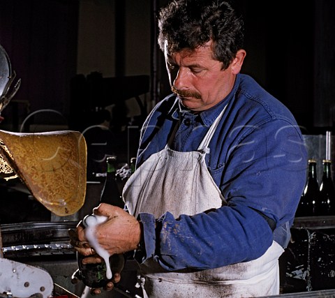 Degorgement by hand at Champagne Bollinger Ay Marne France