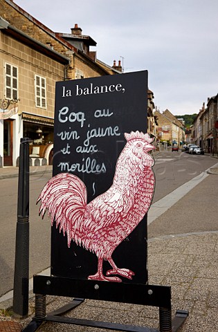 Coq au Vin Jaune et aux Morilles sign outside La Balance restaurant Arbois Jura France