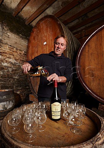 Frdric Lornet pouring Savagnin and Trousseau in his winery tasting room the former Cistercian LAbbaye de Genne  MontignylsArsures Jura France Arbois