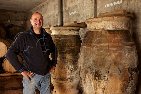 Stphane Tissot with amphorae used for ageing Savagnin and sometimes Trousseau in winery of Domaine Andr et Mireille Tissot MontignylsArsures Jura France  Arbois
