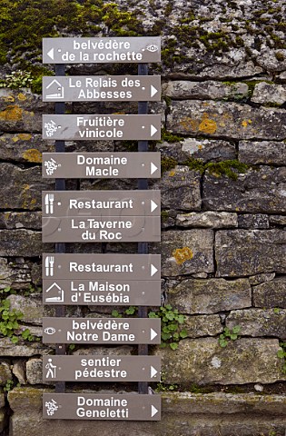 Signs to wineries and restaurants in the village of ChteauChalon Jura France
