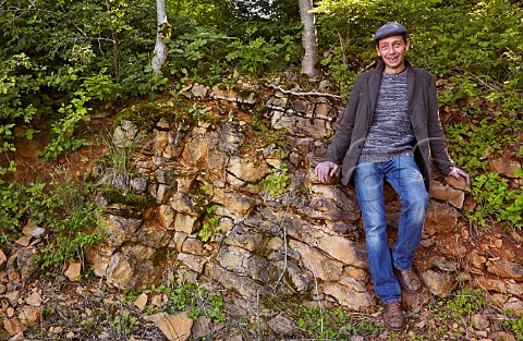 Julien Labet with a soil profile of red limestone below Les Varrons vineyard of Domaine Labet Rotalier Jura France Ctes du Jura