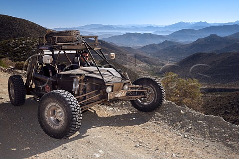 Baja 1000 race car belonging to The Gentleman Driver company on a road overlooking Las Chinchillas National Reserve Coquimbo region Chile