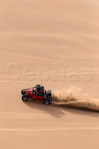 Baja 1000 race car of The Gentleman Driver company negotiating sand dunes in the Atacama Desert Chile